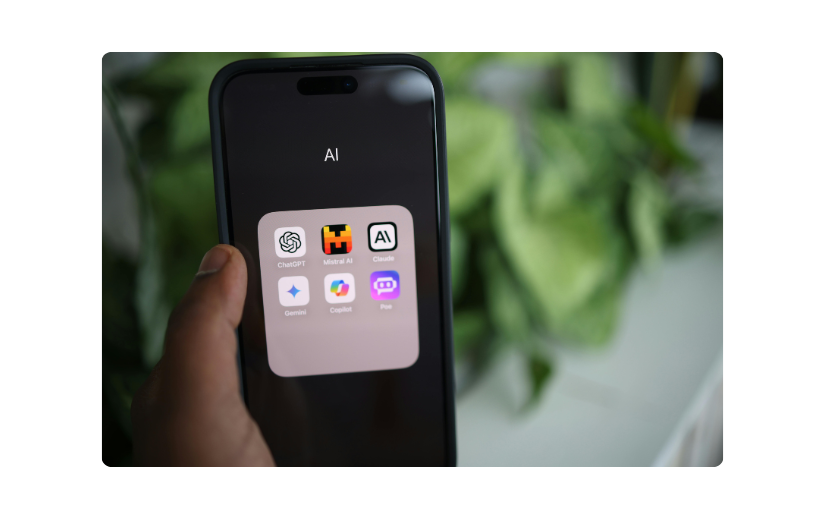 Smartphone showing a folder of AI apps, showcasing tools for side hustle ideas and making money online with AI.